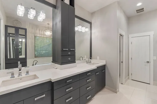 a bathroom with double sink and a mirror