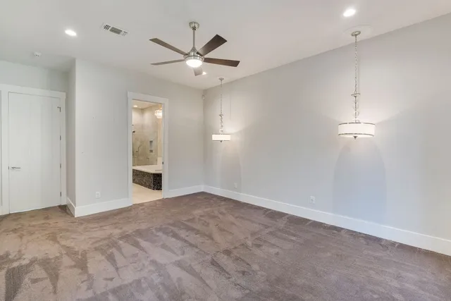 an empty room with fan and entrance