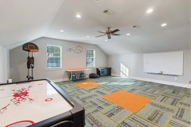 a bedroom with a bed a rug and chair