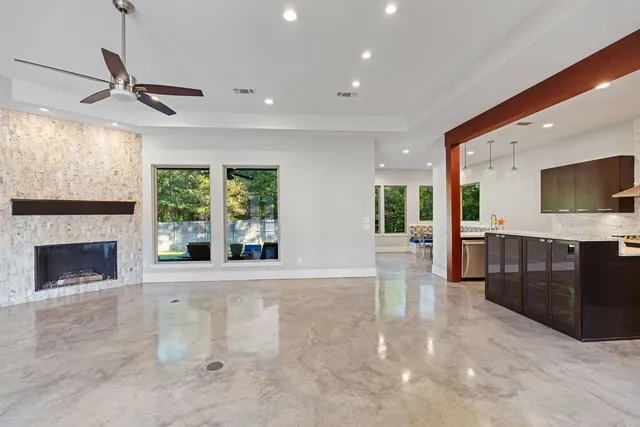 a view of an empty room with a fireplace and a window