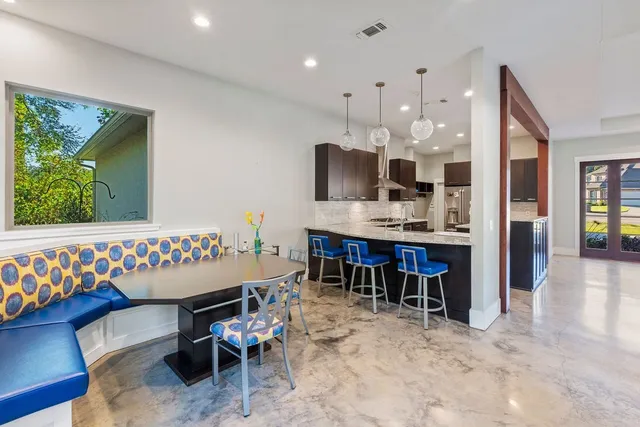 a dining room with furniture and a kitchen view