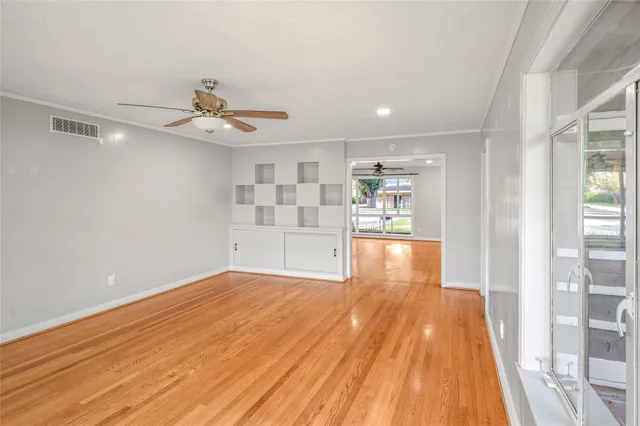 a view of a room with wooden floors and natural light