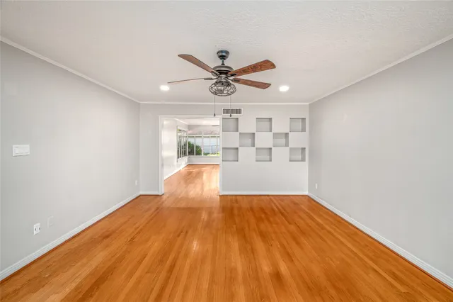 a view of empty room with wooden floor