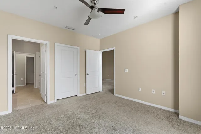 a view of a room with a ceiling fan