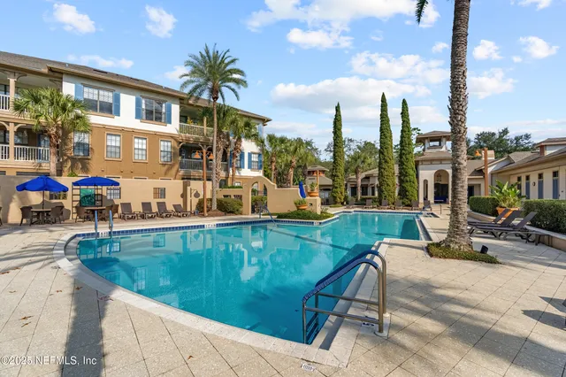 a view of a swimming pool with outdoor seating