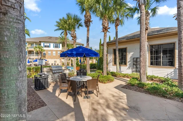 a view of a table and chairs under an umbrella in patio