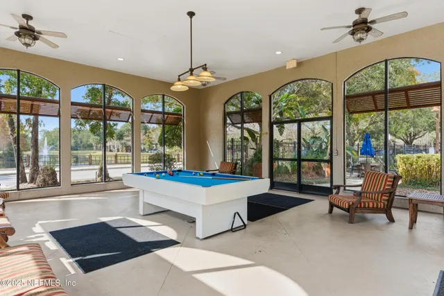 a very nice looking living room with a large window and a dining table