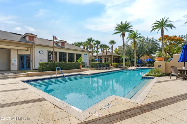 a view of a swimming pool with a lounge chairs