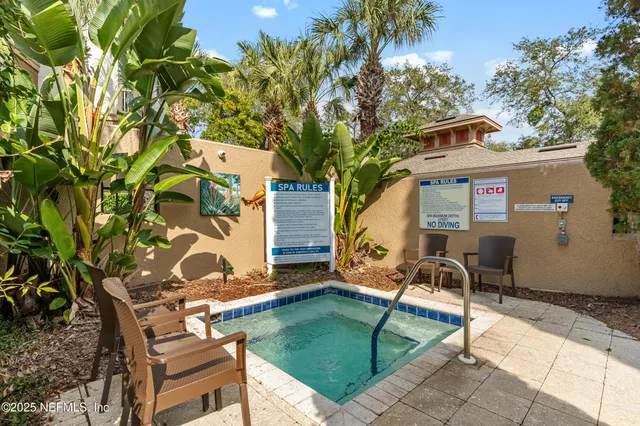 a backyard of a house with table and chairs