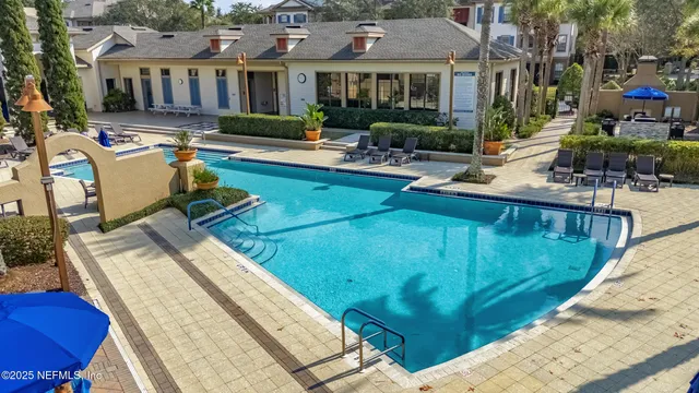 a view of a house with pool and chairs