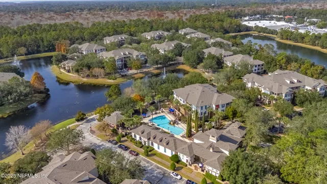 an aerial view of a house with a lake view