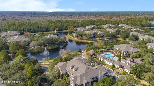 an aerial view of residential house with outdoor space and lake view