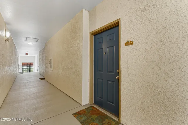a view of a hallway with wooden walls and entryway
