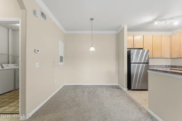 a view of a kitchen with a refrigerator cabinets and a sink