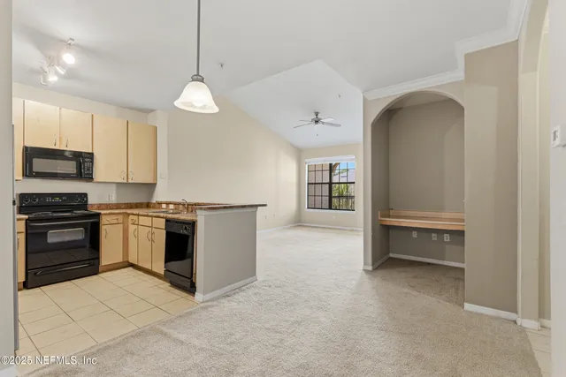 a kitchen with stainless steel appliances granite countertop a stove and a refrigerator