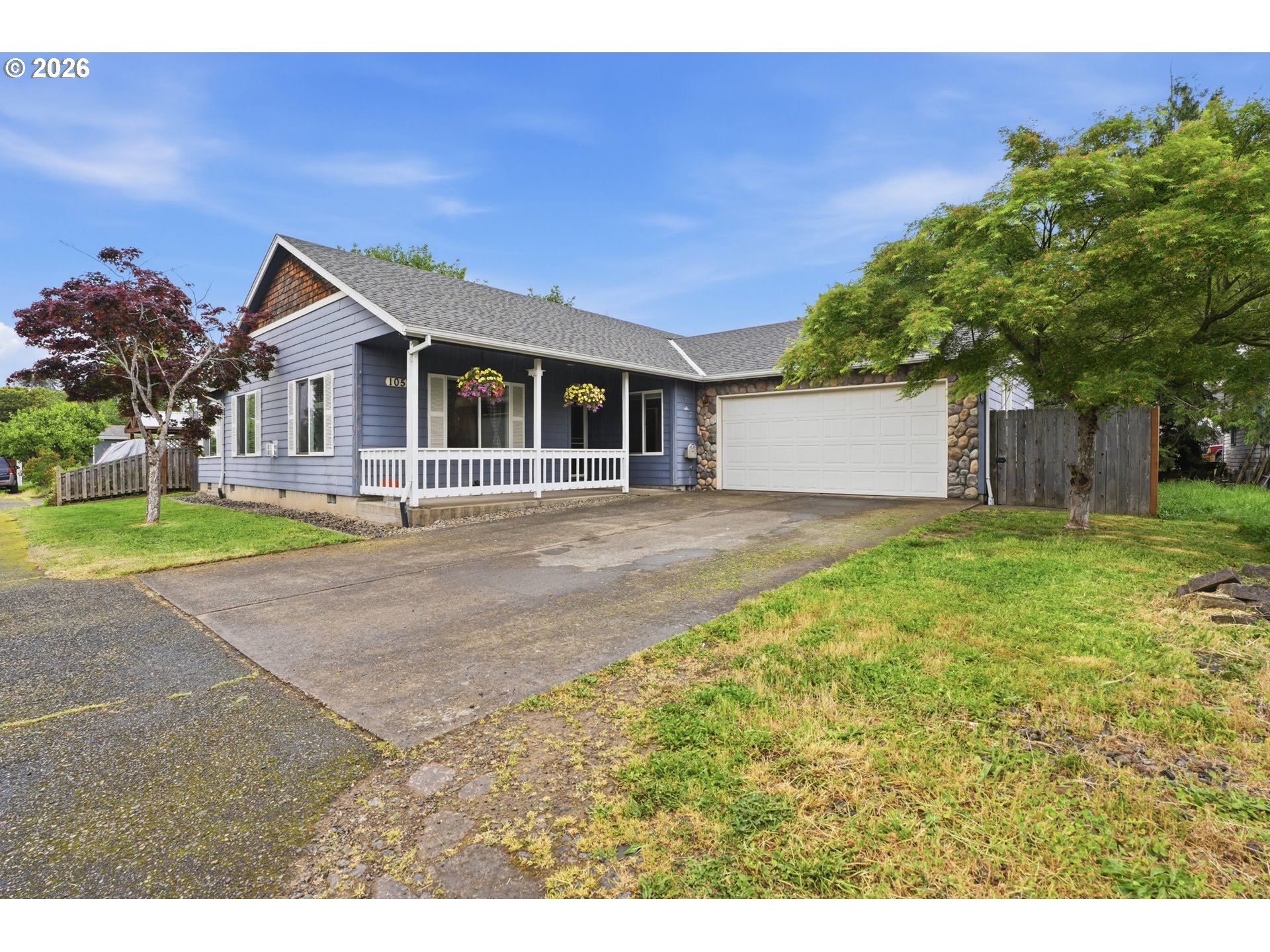 105 Toliver Road Molalla, OR 97038 - Photo 1 of 34 a front view of a house with a garden and yard