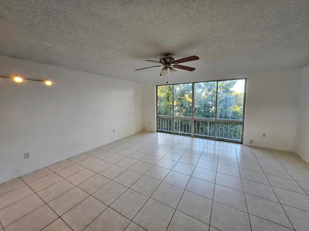 8401 West Sample Road, Unit 36 Coral Springs, FL 33065 - Photo 2 of 11 a view of an empty room with a window