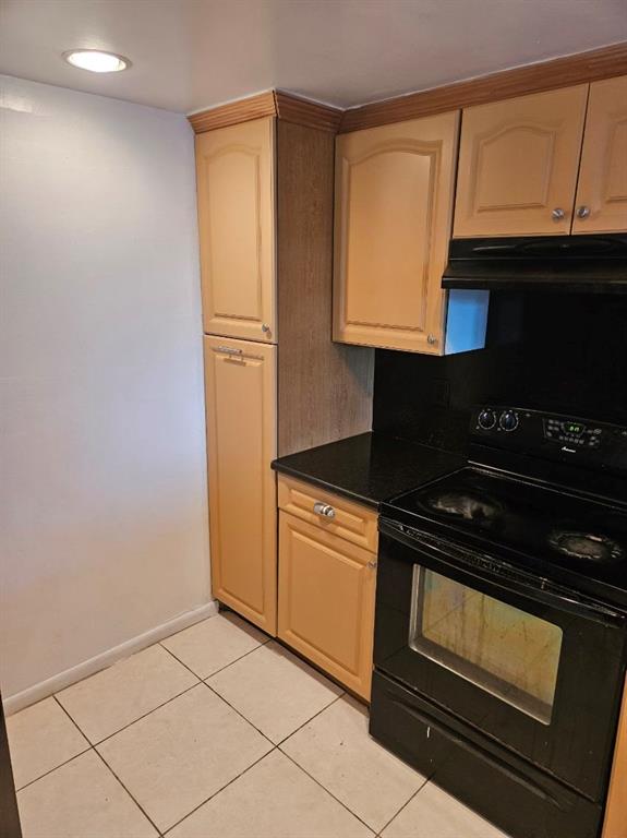 8401 West Sample Road, Unit 36 Coral Springs, FL 33065 - Photo 3 of 11 a kitchen with granite countertop a stove and a microwave