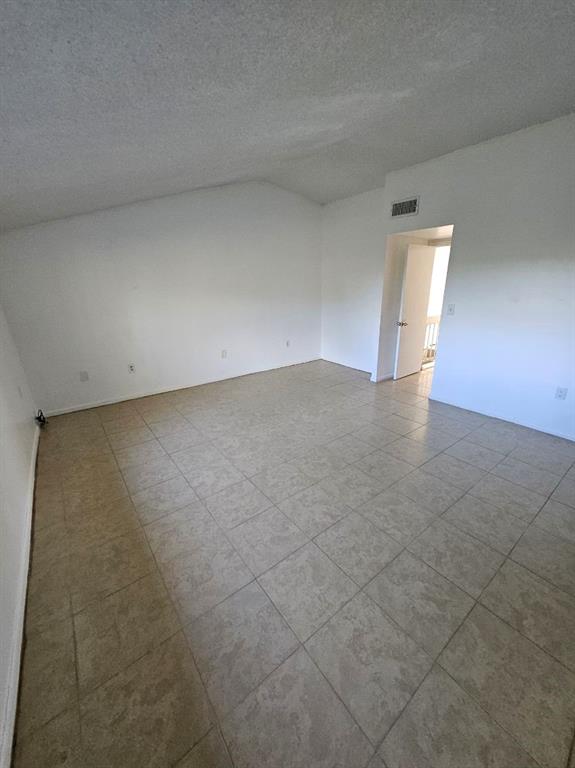 8401 West Sample Road, Unit 36 Coral Springs, FL 33065 - Photo 6 of 11 a view of an empty room with a window