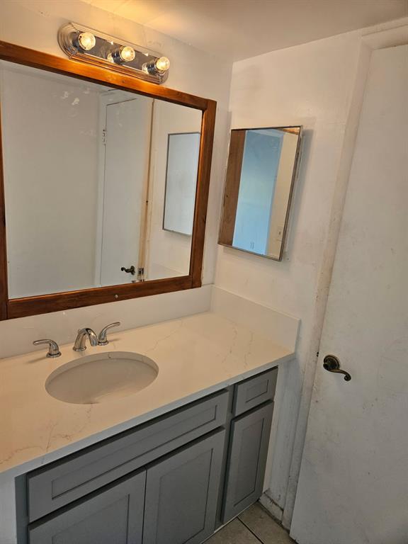 8401 West Sample Road, Unit 36 Coral Springs, FL 33065 - Photo 7 of 11 a bathroom with a sink vanity and mirror