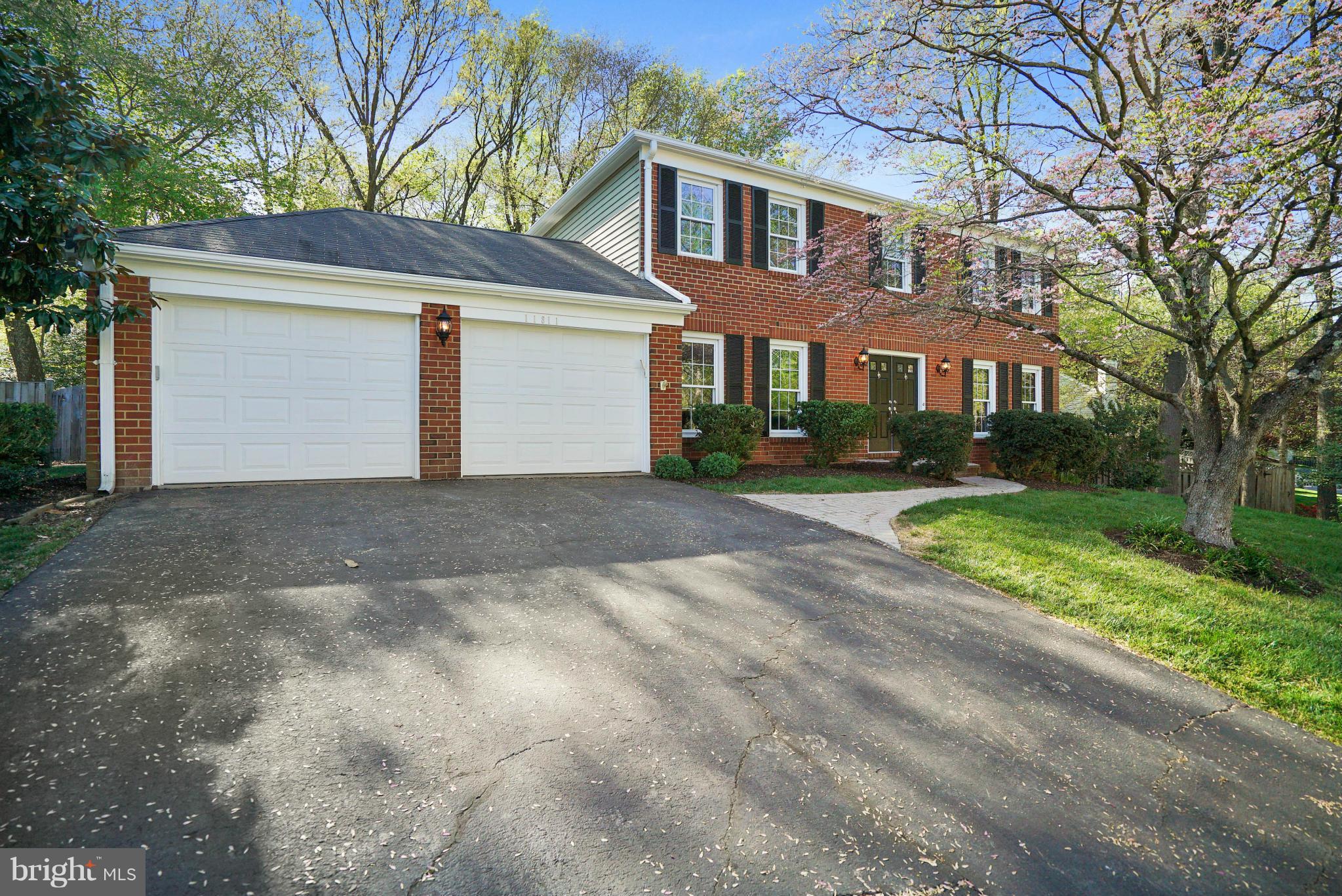 11811 Grey Birch Place Reston, VA 20191 - Photo 2 of 30 a front view of a house with a yard and garage