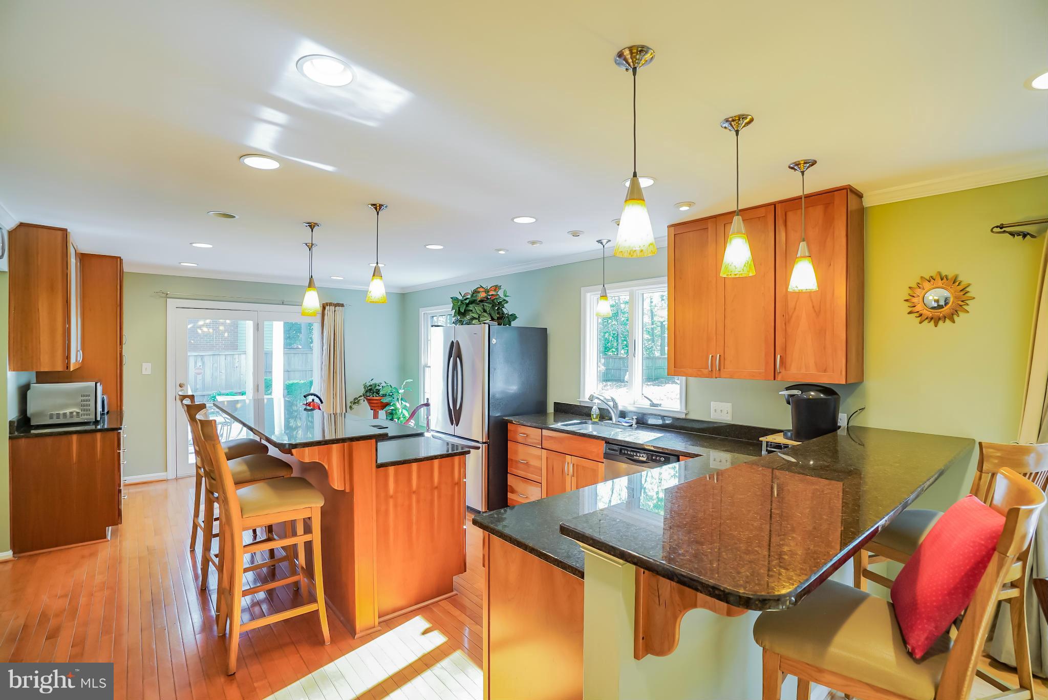 11811 Grey Birch Place Reston, VA 20191 - Photo 9 of 30 a kitchen with stainless steel appliances granite countertop a sink a stove and a refrigerator