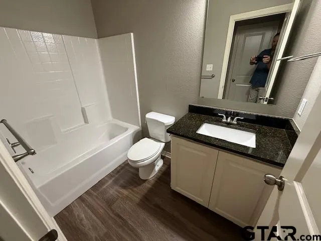 a bathroom with a toilet a sink and bathtub