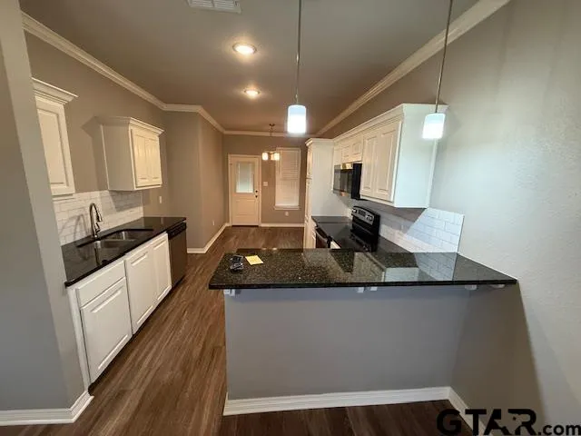 a kitchen with a sink stove and microwave