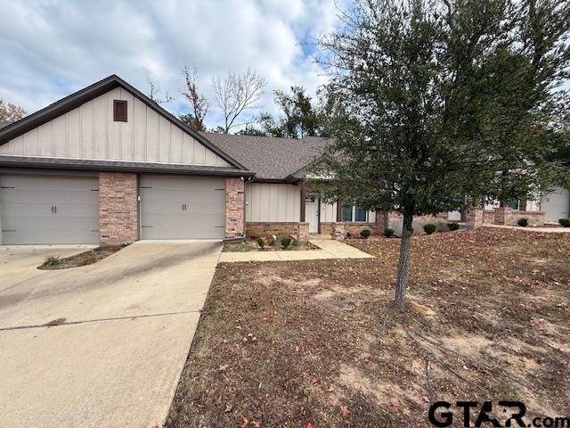 1714 Pine Crest Drive, Unit 103 Tyler, TX 75701 - Photo 10 of 11 a front view of a house with a yard and garage