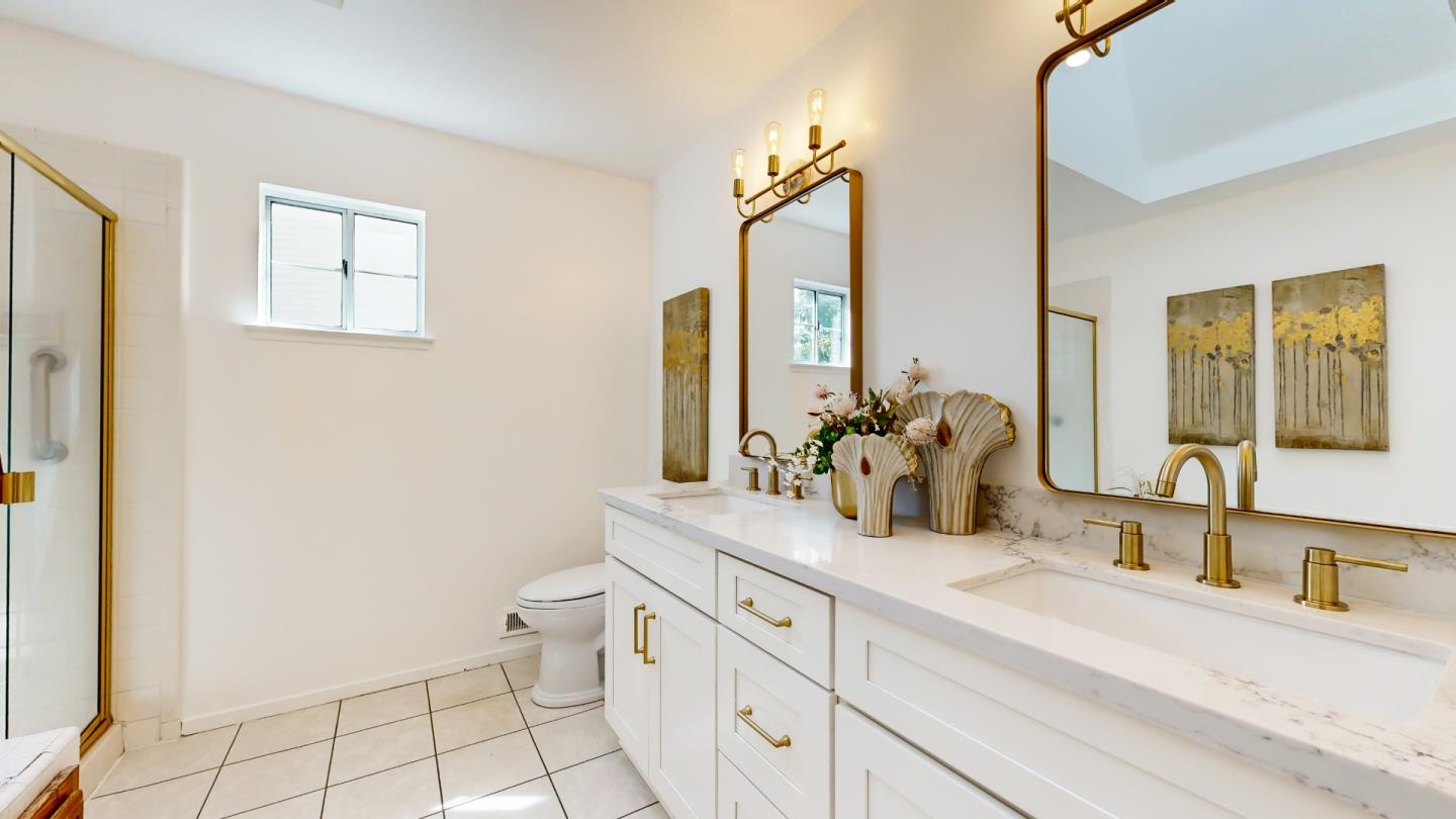 890 Windmill Park Lane Mountain View, CA 94043 - Photo 18 of 27 a bathroom with a double vanity sink toilet and a mirror