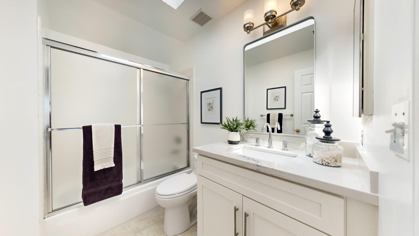 890 Windmill Park Lane Mountain View, CA 94043 - Photo 22 of 27 a bathroom with a granite countertop sink a toilet a mirror and shower