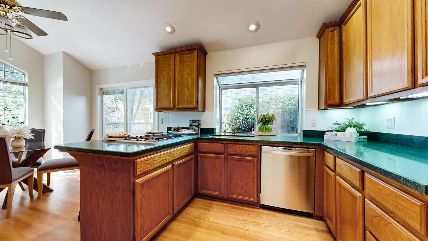 890 Windmill Park Lane Mountain View, CA 94043 - Photo 4 of 27 a kitchen with stainless steel appliances granite countertop sink stove top oven and cabinets