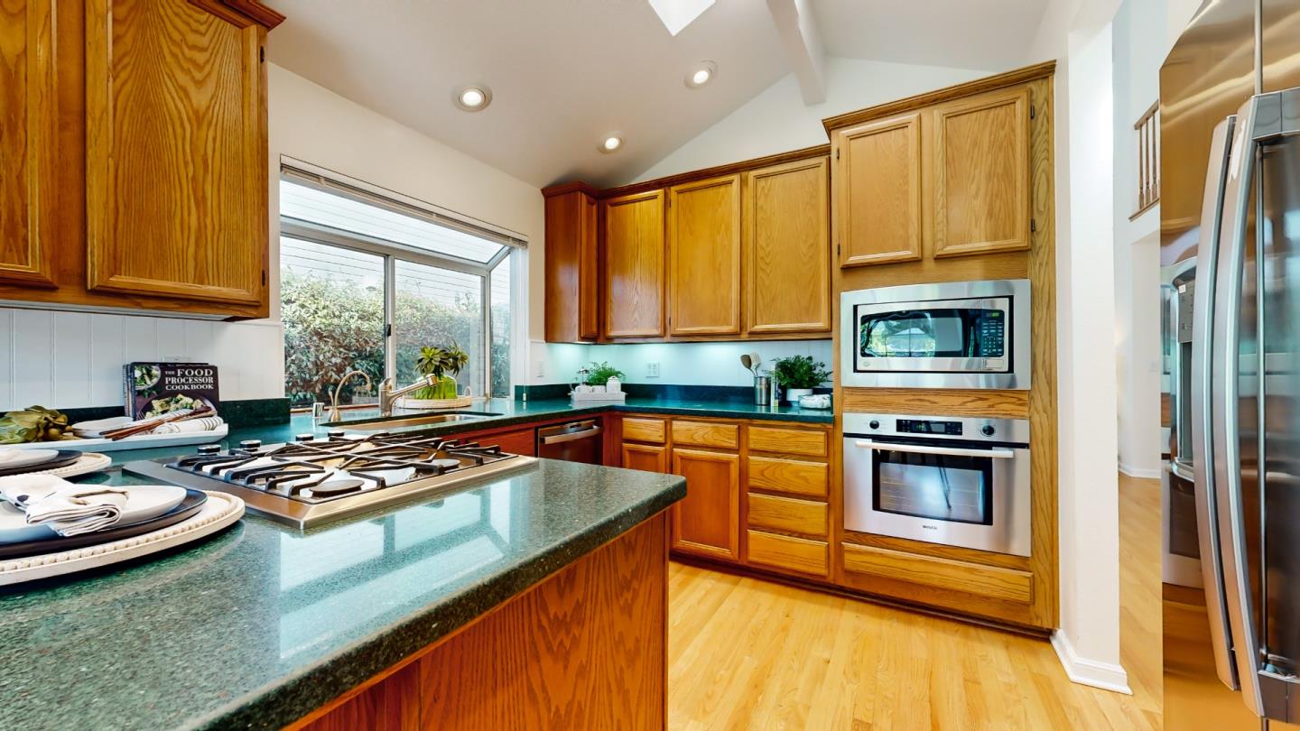 890 Windmill Park Lane Mountain View, CA 94043 - Photo 7 of 27 a kitchen with stainless steel appliances granite countertop a sink stove and refrigerator