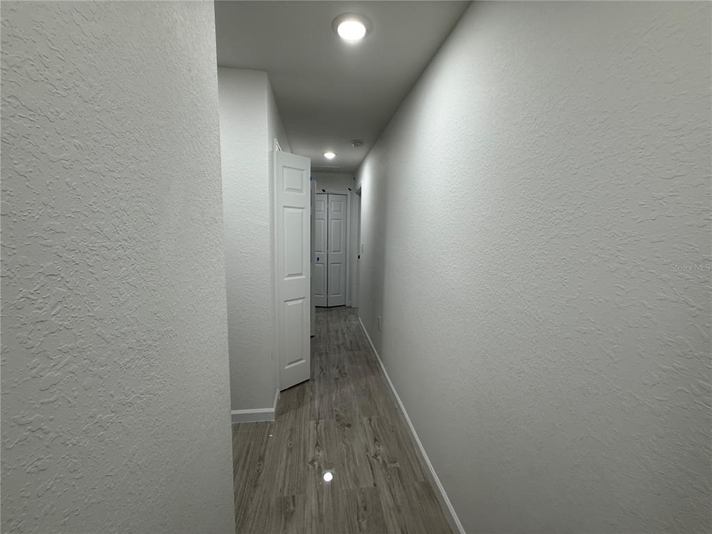 5358 Rhapsody Avenue North Port, FL 34288 - Photo 13 of 28 a view of hallway with wooden floor