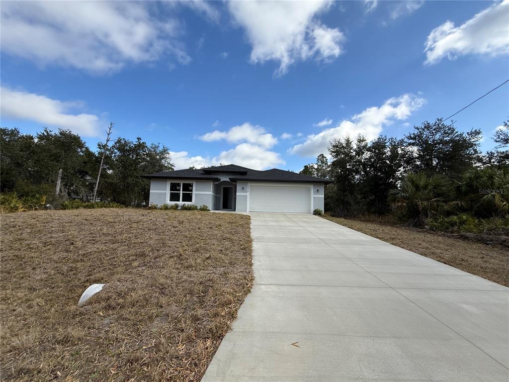 5358 Rhapsody Avenue North Port, FL 34288 - Photo 28 of 28 a front view of a house with a yard and mountain view