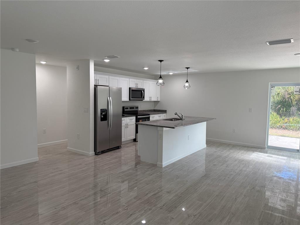 5358 Rhapsody Avenue North Port, FL 34288 - Photo 6 of 28 a view of kitchen with refrigerator and microwave