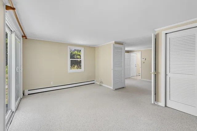 view of a house with a yard and garden