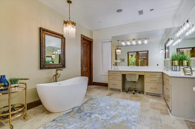a bathroom with a tub sink and mirror