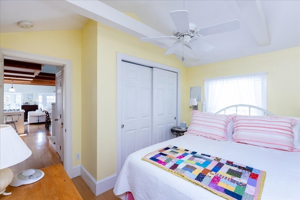 145 Evans Rd Extension Marblehead, MA 01945 - Photo 19 of 42 a bedroom with a bed and a chandelier