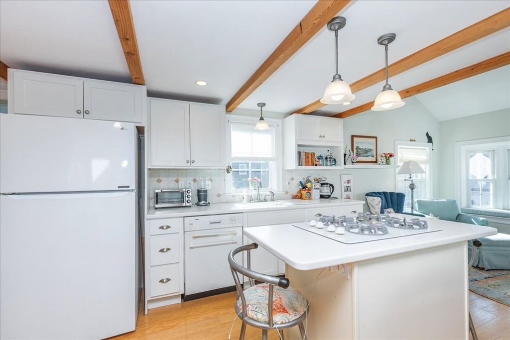 145 Evans Rd Extension Marblehead, MA 01945 - Photo 2 of 42 a kitchen with a sink a stove a refrigerator cabinets and dining table