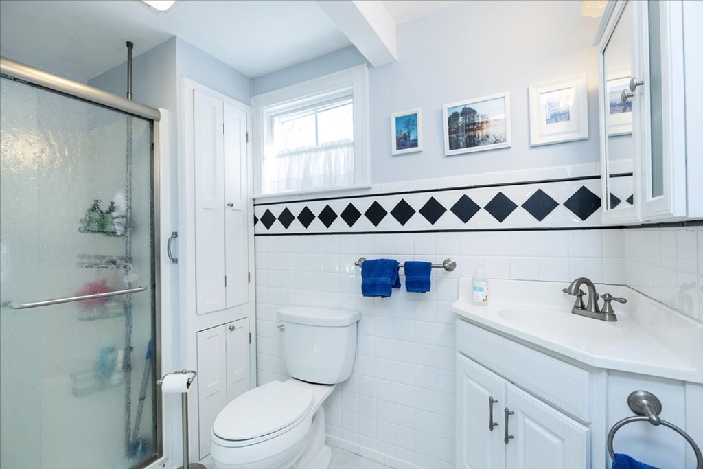 145 Evans Rd Extension Marblehead, MA 01945 - Photo 24 of 42 a white toilet sitting next to a bathroom sink