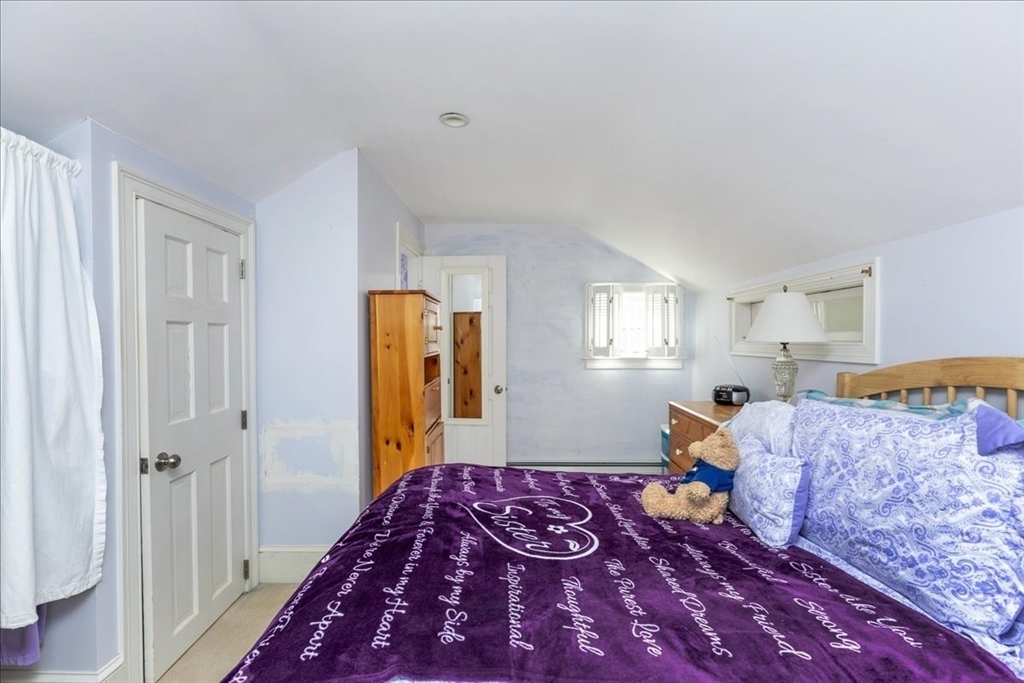 145 Evans Rd Extension Marblehead, MA 01945 - Photo 25 of 42 a bedroom with bed and wooden floor