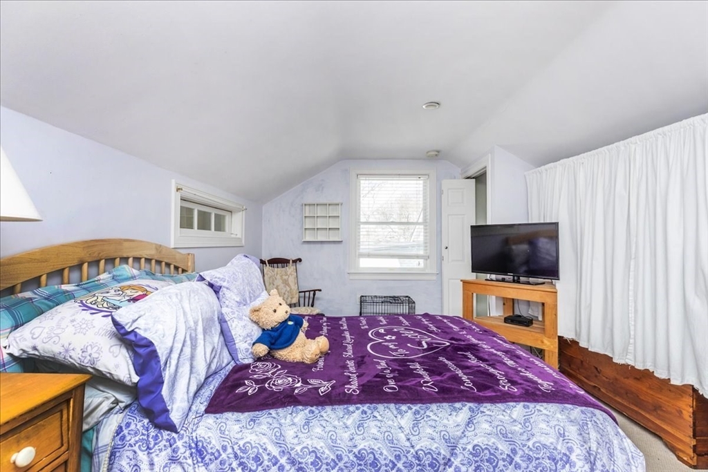 145 Evans Rd Extension Marblehead, MA 01945 - Photo 26 of 42 a bedroom with a bed and a flat screen tv
