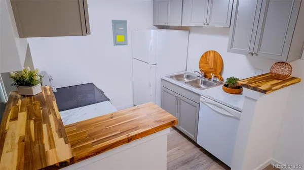 a bed sitting in a kitchen next to a window