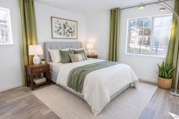 a large bed sitting in a bedroom next to a window