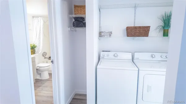 a bathroom with a toilet a sink and a view of bathroom