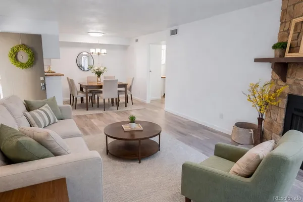 a living room with furniture and a wooden floor