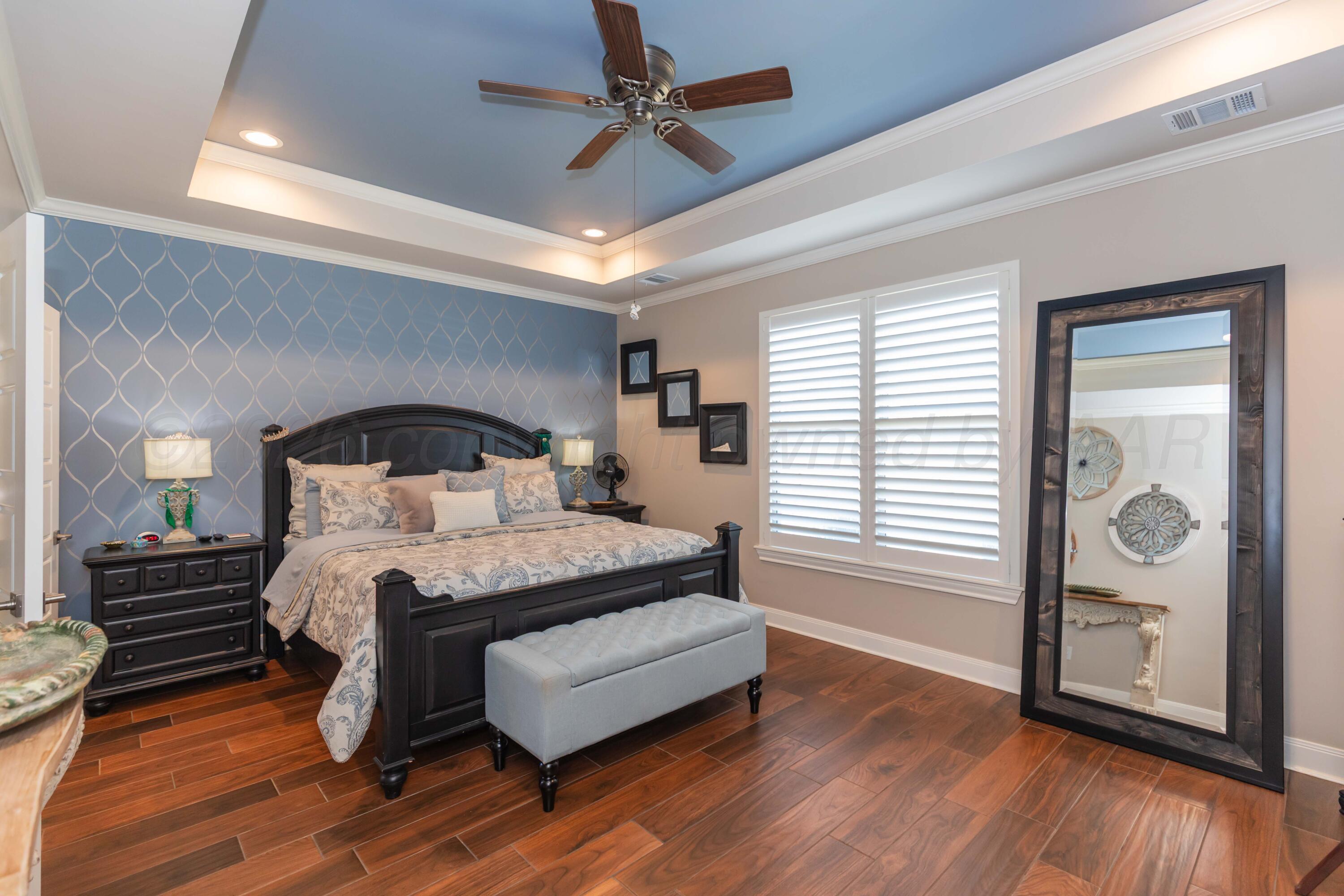 2809 Pensacola Avenue Amarillo, TX 79118 - Photo 13 of 36 a bedroom with a bed lamp and a large window with wooden floor