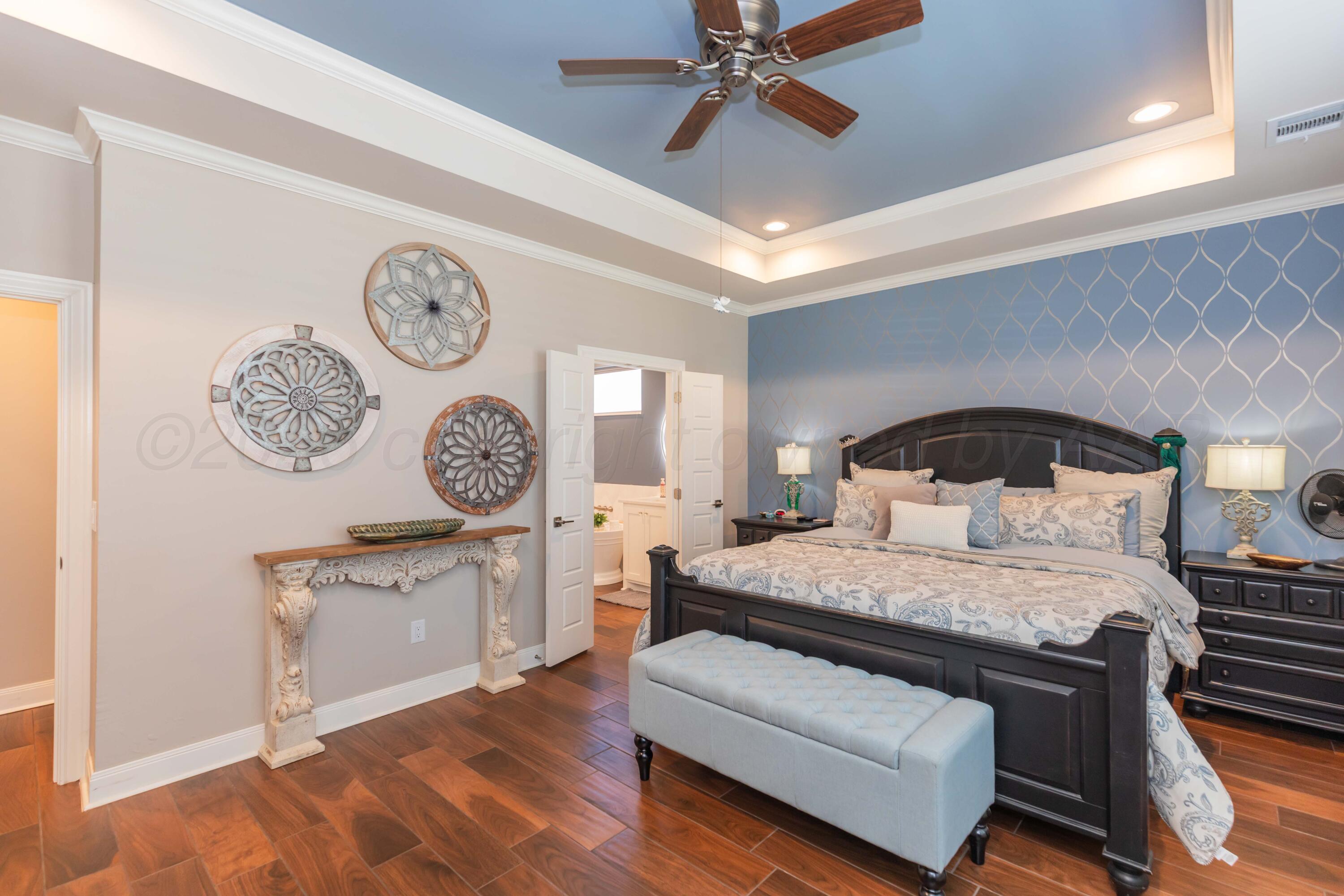 2809 Pensacola Avenue Amarillo, TX 79118 - Photo 14 of 36 a bedroom with a bed and a chandelier