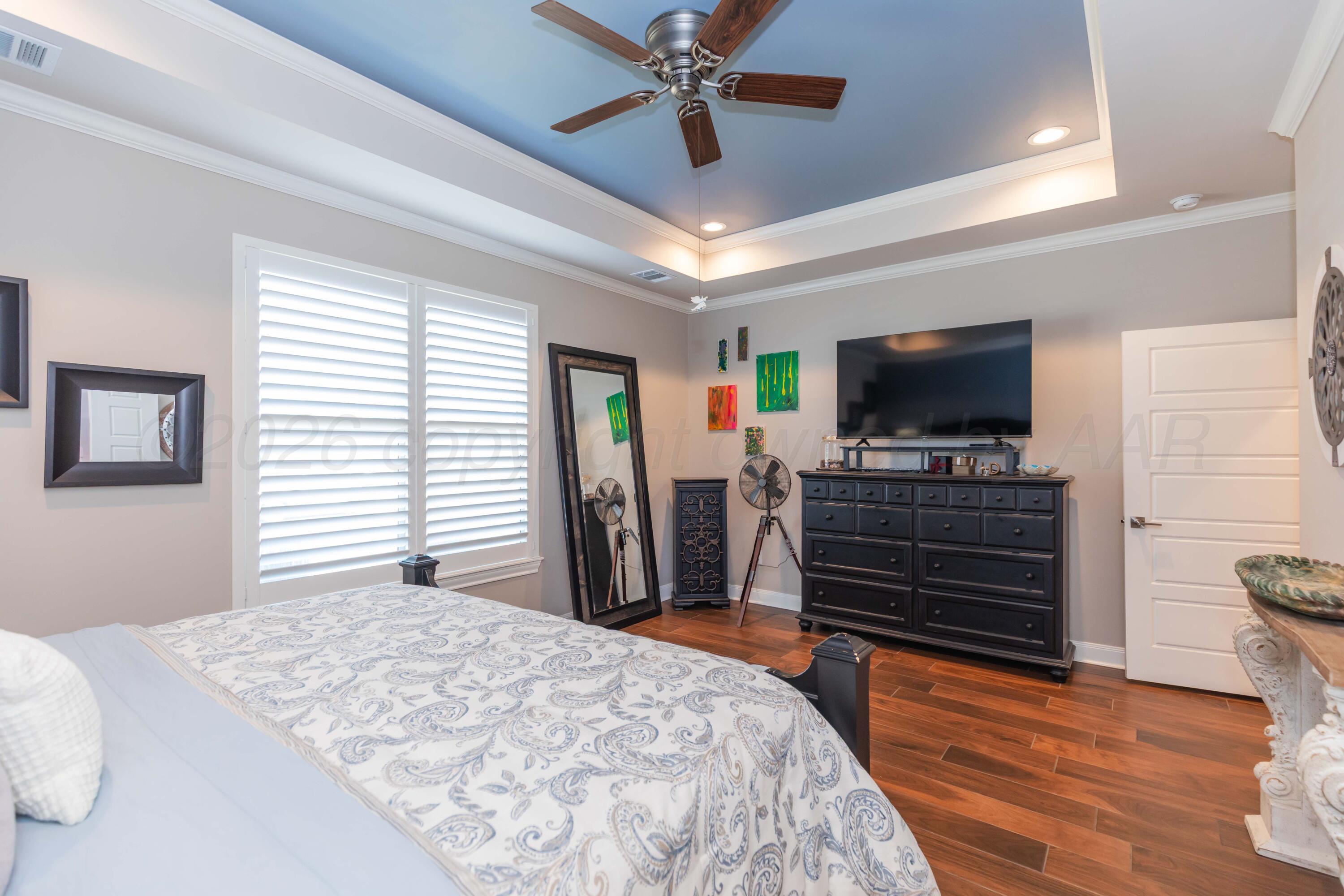 2809 Pensacola Avenue Amarillo, TX 79118 - Photo 16 of 36 a bedroom with a bed and a flat screen tv